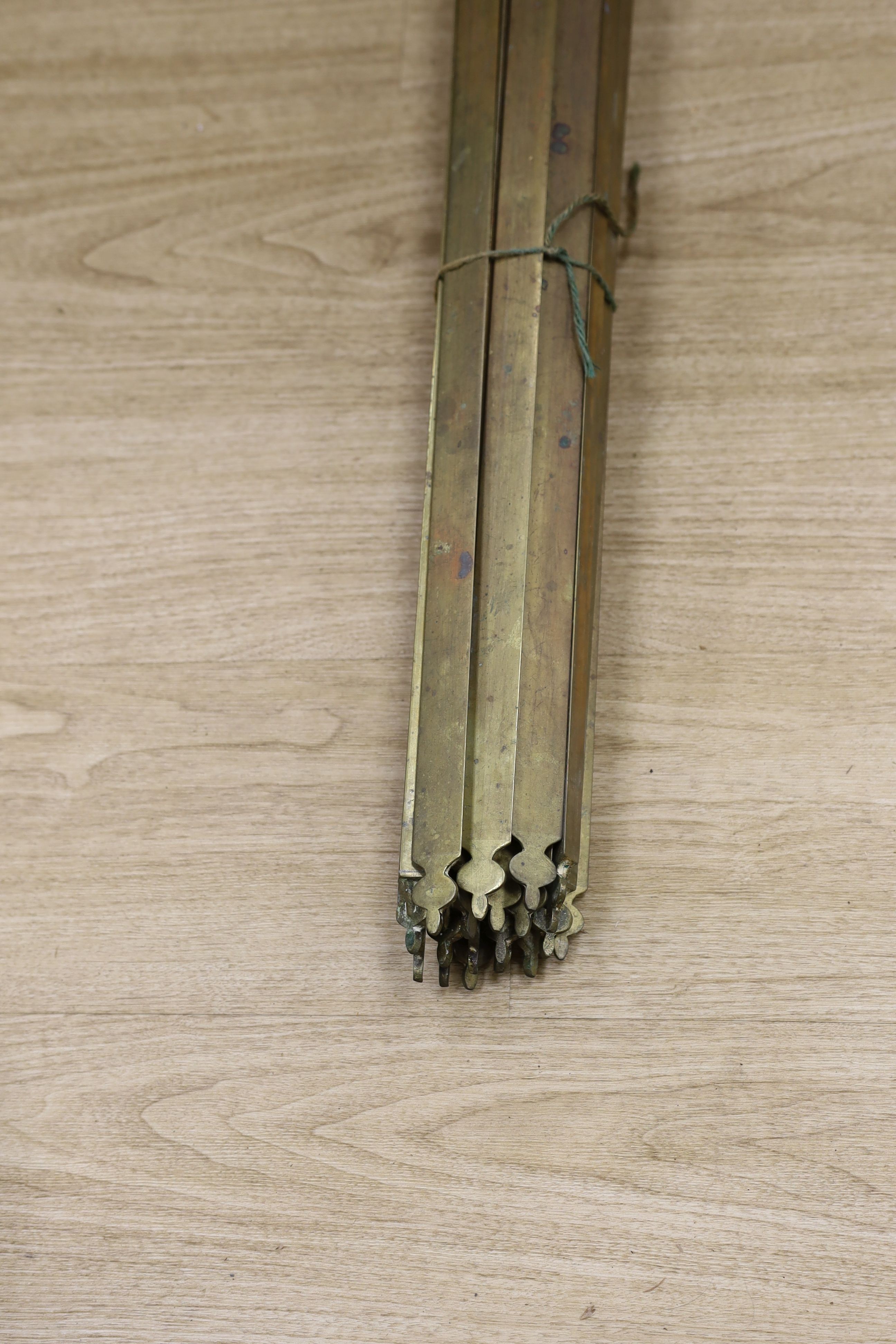Two sets of brass stair rods with fittings.